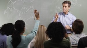 Chemistry Teacher with Students in Class --- Image by © Royalty-Free/Corbis